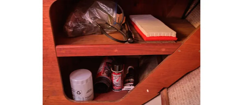 Slide: The Image of Wooden storage shelf with various maintenance supplies on a 1980 Sceptre 36 Athena boat. - 37