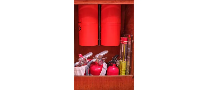 Slide: The Image of Safety equipment storage on 1980 Sceptre 36 Athena boat, featuring fire extinguishers and flares. - 38