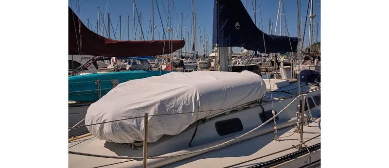 Slide: The Image of 1980 Sceptre 36 Athena sailboat docked in marina, covered and surrounded by other boats. - 4