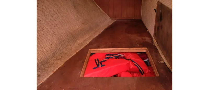 Slide: The Image of Storage compartment with red life jackets on a 1980 Sceptre 36 Athena boat. - 41