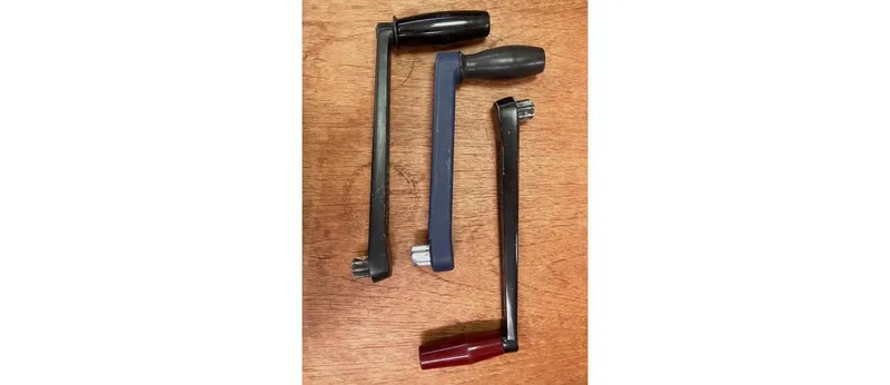 Slide: The Image of Four vintage Sceptre 36 Athena 1980 window cranks on wooden surface. - 44