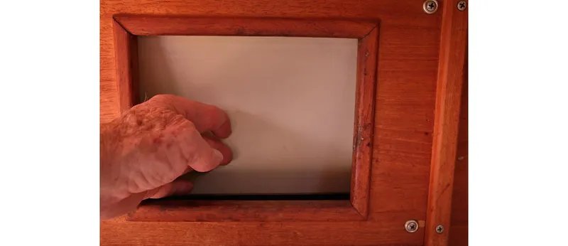 Slide: The Image of Hand opening wooden hatch on 1980 Sceptre 36 Athena boat. - 47