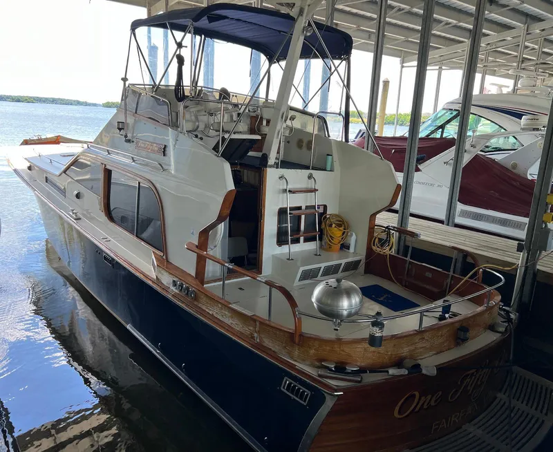 The Image of 1986 Midnight Lace 44 Flybridge Express Cruiser docked in a marina. - 0