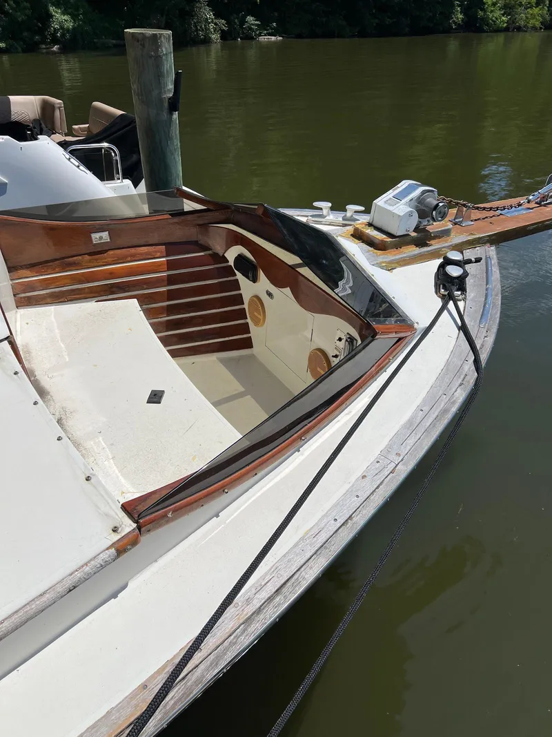 Slide: The Image of 1986 Midnight Lace 44 Flybridge Express Cruiser docked on calm water. - 11