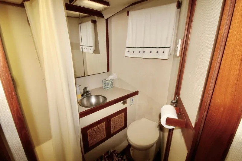 Slide: The Image of 1986 Midnight Lace 44 Flybridge Express Cruiser bathroom with sink, toilet, and mirror. - 15