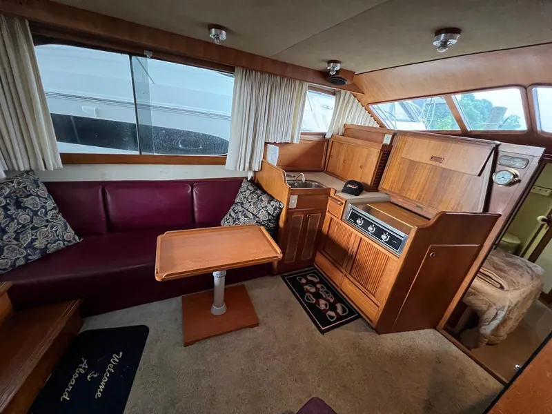 Slide: The Image of Interior of 1986 Midnight Lace 44 Flybridge Express Cruiser with wood cabinetry and seating area. - 17