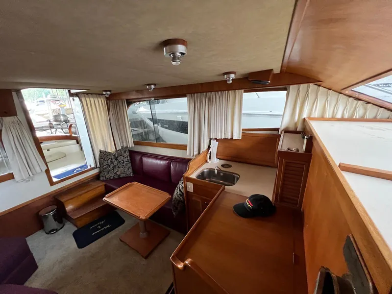 Slide: The Image of Interior of 1986 Midnight Lace 44 Flybridge Express Cruiser with wood accents and seating area. - 20