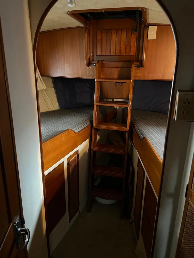 Slide: The Image of Interior cabin of 1986 Midnight Lace 44 Flybridge Express Cruiser with wooden bunk beds. - 22