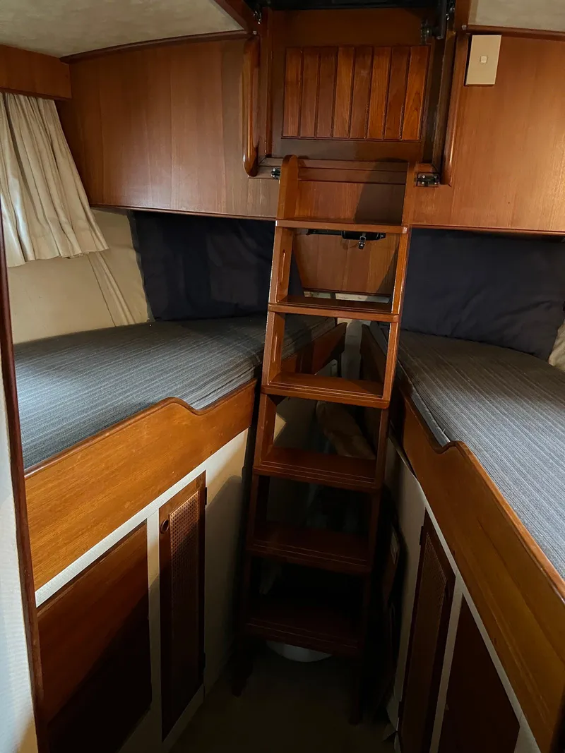 Slide: The Image of Interior of 1986 Midnight Lace 44 Flybridge Express Cruiser with wooden ladder and twin beds. - 24