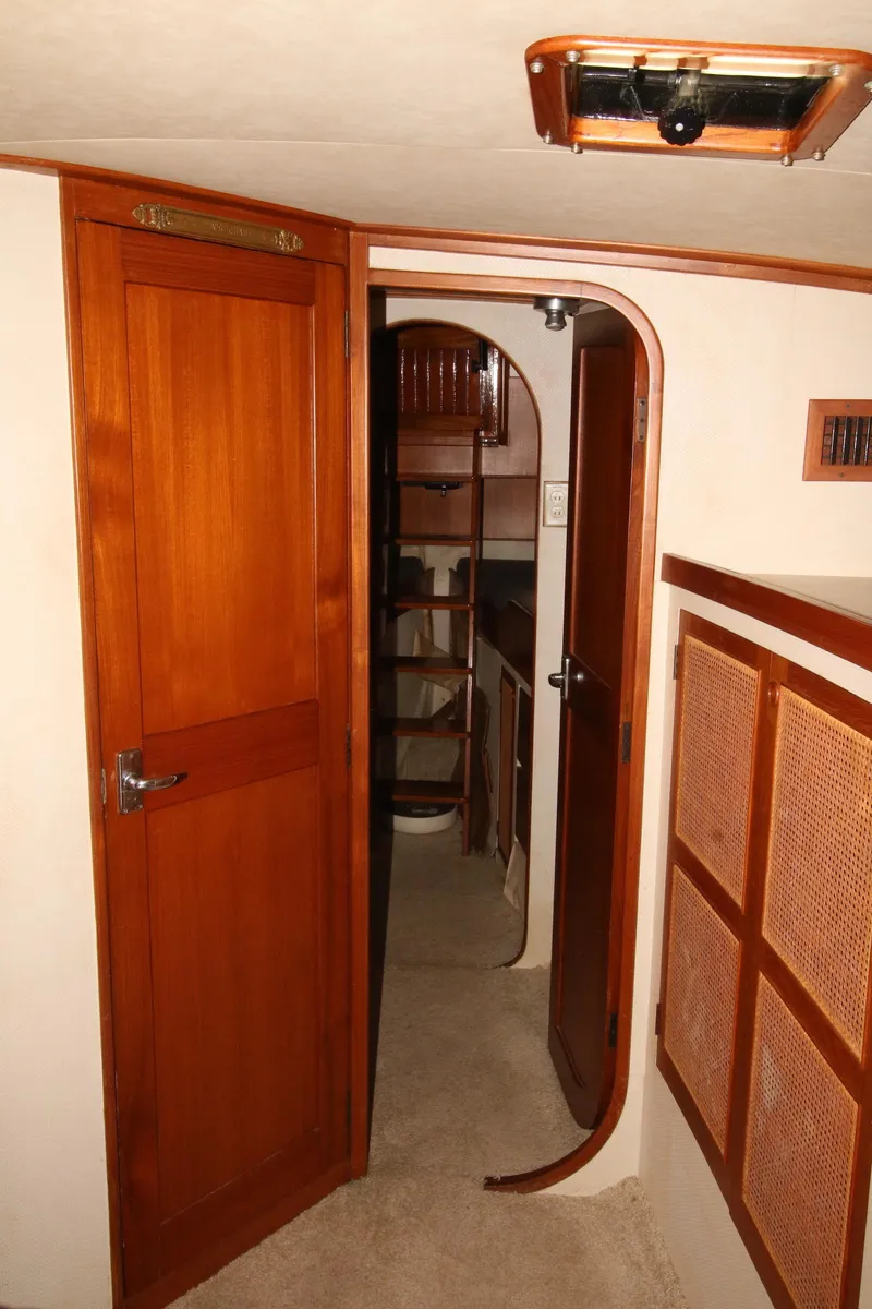 Slide: The Image of Interior of 1986 Midnight Lace 44 Flybridge Express Cruiser with wooden doors and cabinetry. - 25