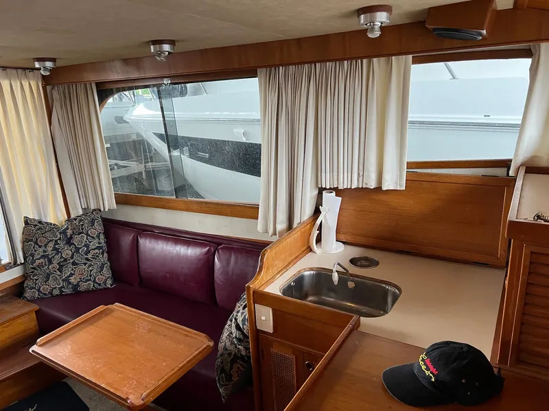 Slide: The Image of Interior of 1986 Midnight Lace 44 Flybridge Express Cruiser with seating and kitchenette. - 27