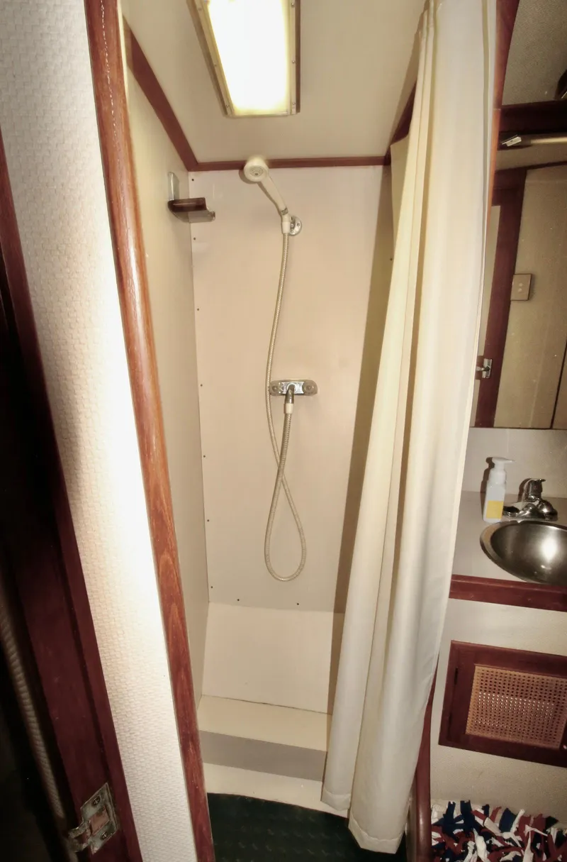 Slide: The Image of 1986 Midnight Lace 44 Flybridge Express Cruiser bathroom with shower and sink. - 28