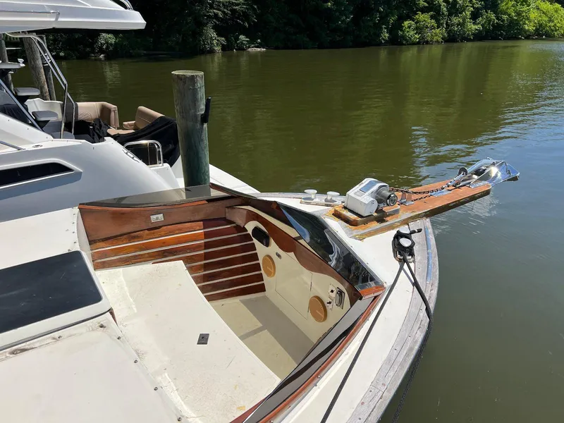 Slide: The Image of 1986 Midnight Lace 44 Flybridge Express Cruiser docked on a calm river. - 3