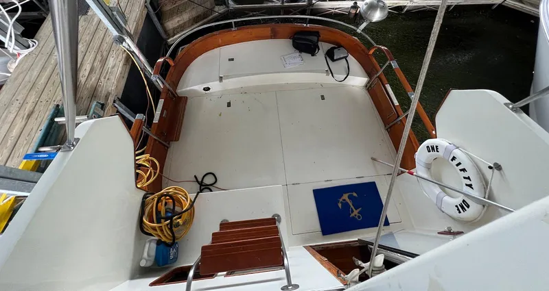 Slide: The Image of 1986 Midnight Lace 44 Flybridge Express Cruiser deck with nautical decor and equipment. - 6