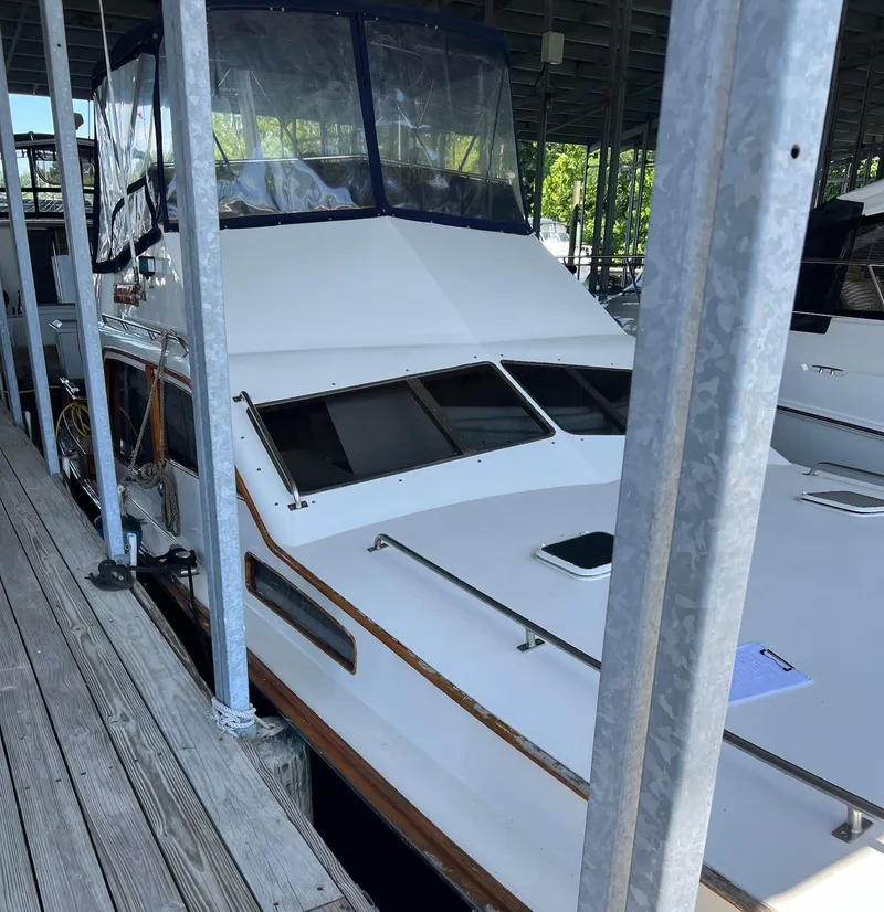 Slide: The Image of 1986 Midnight Lace 44 Flybridge Express Cruiser docked in a marina. - 9