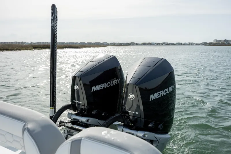 Slide: The Image of Twin Mercury engines on a 2025 Yellowfin 26 Hybrid boat in open water. - 10