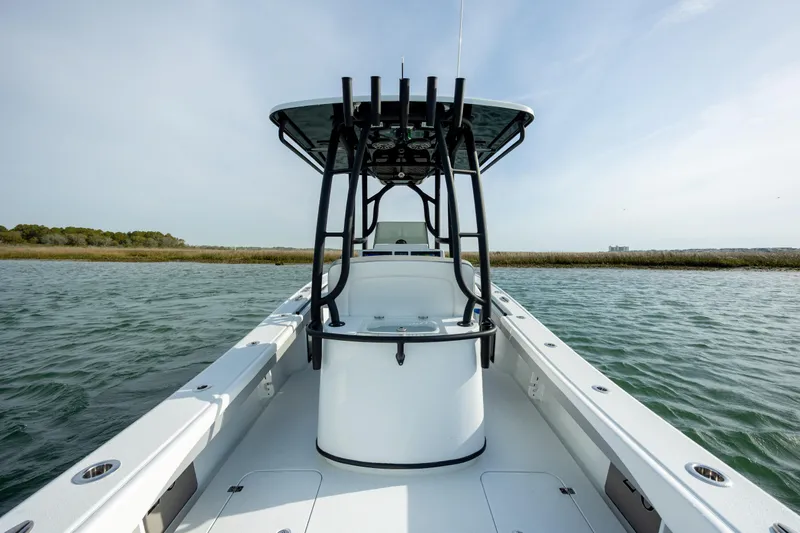 Slide: The Image of 2025 Yellowfin 26 Hybrid boat on water, showcasing sleek design and spacious deck. - 11