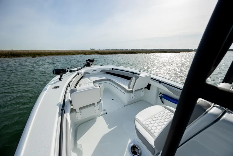 Slide: The Image of 2025 Yellowfin 26 Hybrid boat interior with seating, on calm water. - 18