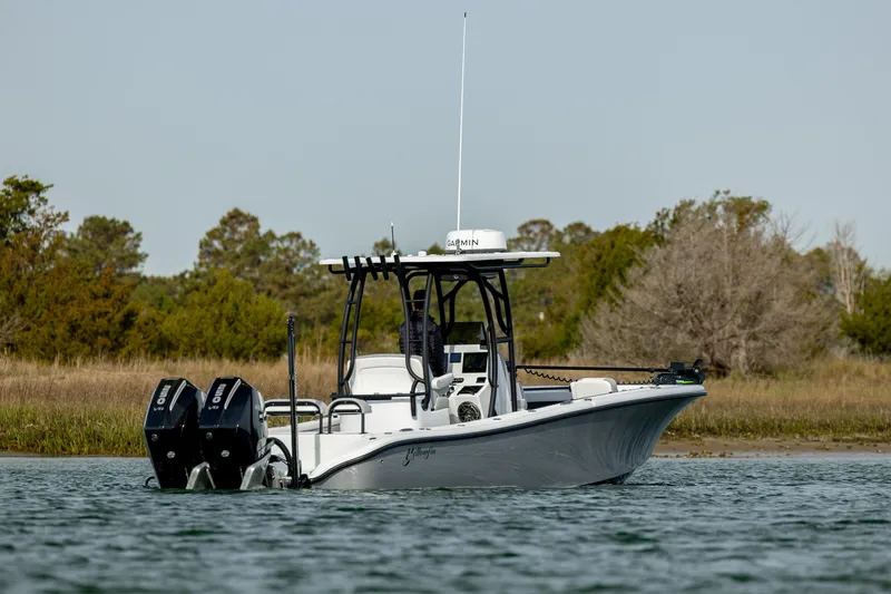 Slide: The Image of 2025 Yellowfin 26 Hybrid boat on water, featuring dual engines and sleek design. - 2