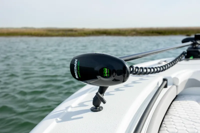 Slide: The Image of 2025 Yellowfin 26 Hybrid boat with trolling motor on calm water. - 21