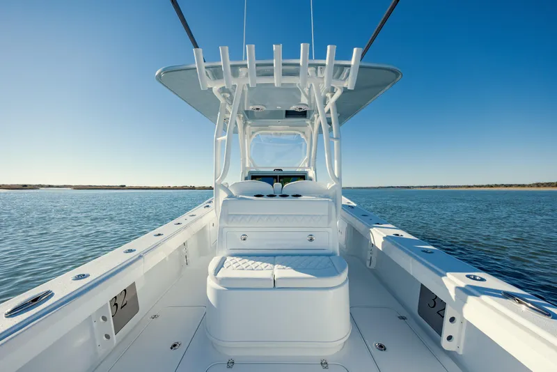 Slide: The Image of 2025 Yellowfin 32 boat on calm water, clear blue sky. - 13