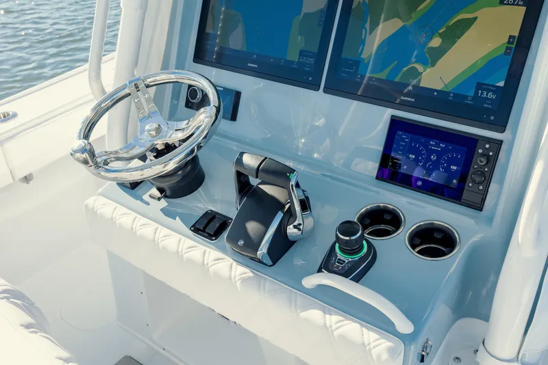 Slide: The Image of 2025 Yellowfin 32 boat dashboard with steering wheel and navigation screens. - 20