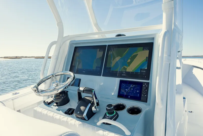 Slide: The Image of 2025 Yellowfin 32 boat dashboard with advanced navigation screens and controls. - 21