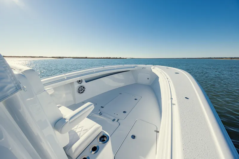 Slide: The Image of 2025 Yellowfin 32 boat on calm water under clear blue sky. - 25