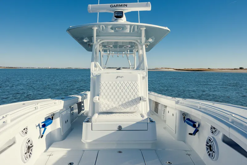 Slide: The Image of 2025 Yellowfin 32 boat on calm water, featuring advanced Garmin navigation. - 27