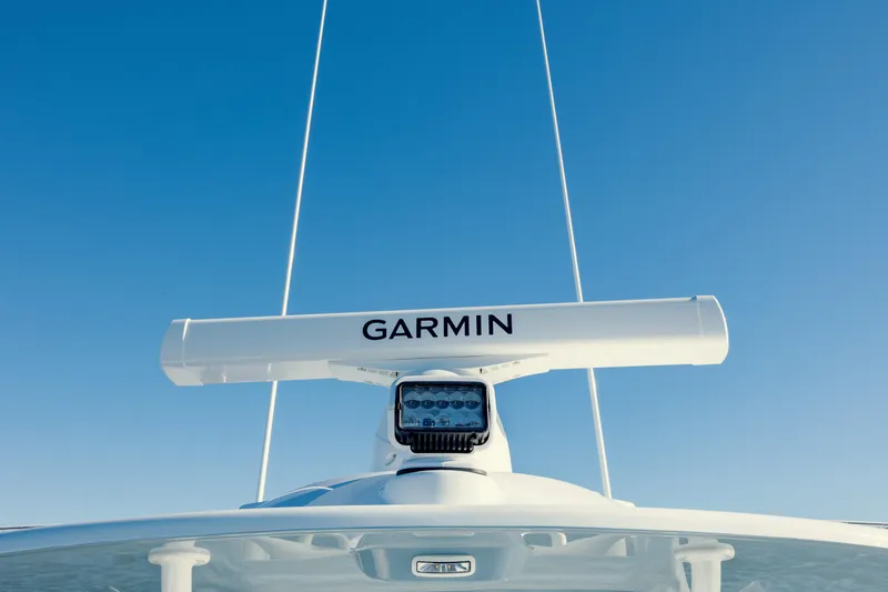 Slide: The Image of 2025 Yellowfin 32 boat with Garmin radar against clear blue sky. - 30