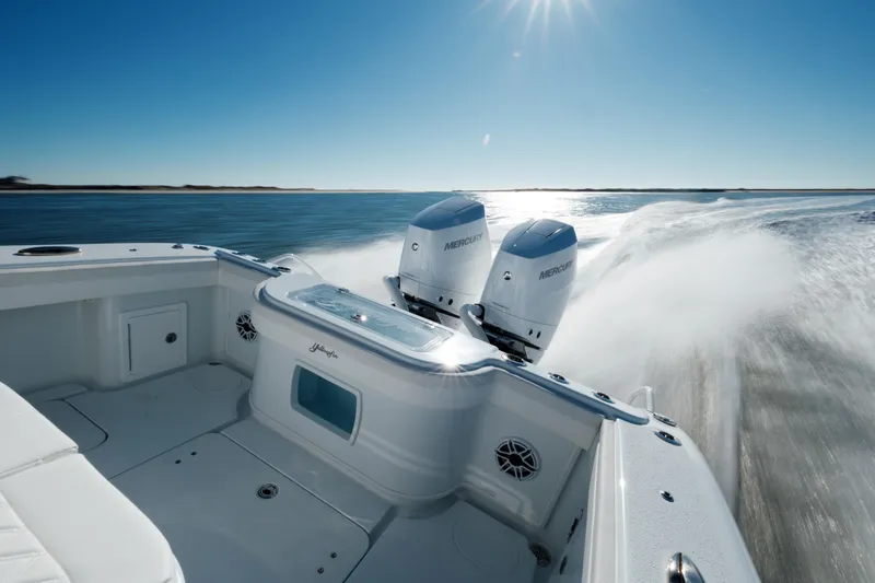 Slide: The Image of 2025 Yellowfin 32 boat speeding on open water under clear blue sky. - 34