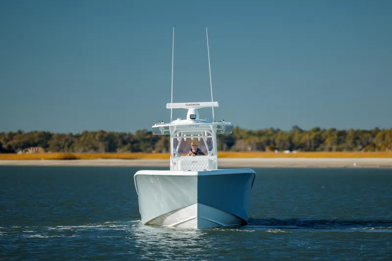 Slide: The Image of 2025 Yellowfin 32 boat cruising on calm water, clear sky background. - 4