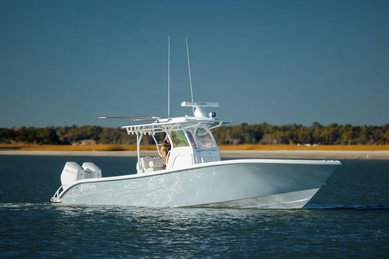 Slide: The Image of 2025 Yellowfin 32 boat cruising on calm water under clear skies. - 5