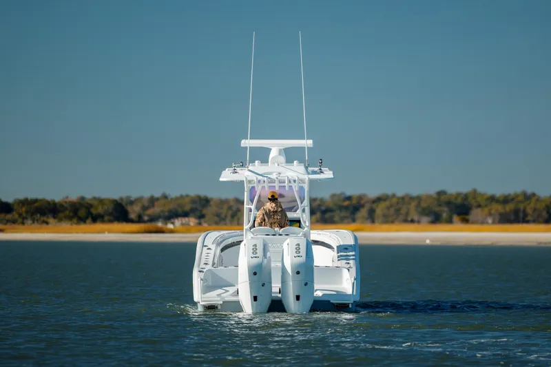 Slide: The Image of 2025 Yellowfin 32 boat on calm water with dual engines. - 7