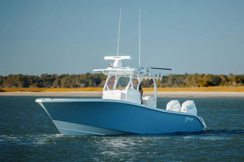 Slide: The Image of 2025 Yellowfin 32 boat cruising on calm water, clear sky background. - 8
