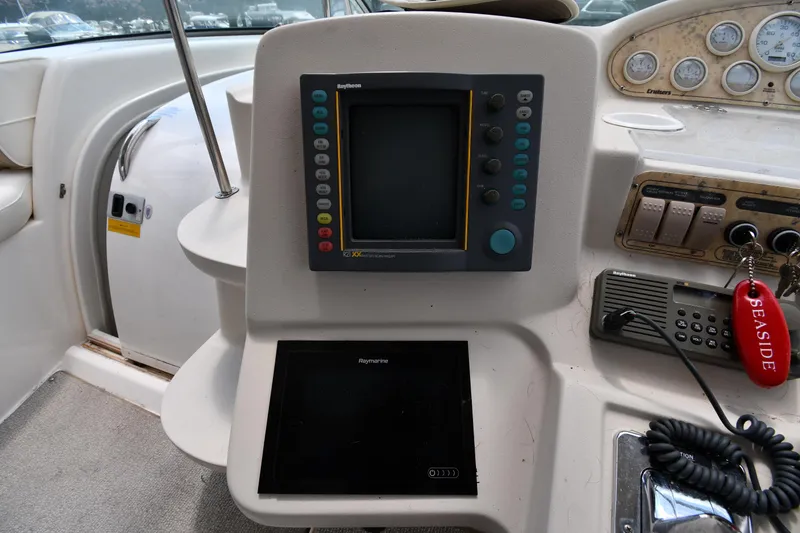 Slide: The Image of 1998 Cruisers Yachts 3870 Express helm with navigation equipment and controls. - 14