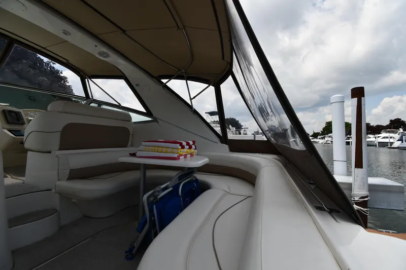 Slide: The Image of 1998 Cruisers Yachts 3870 Express interior with seating and table, docked at marina. - 17
