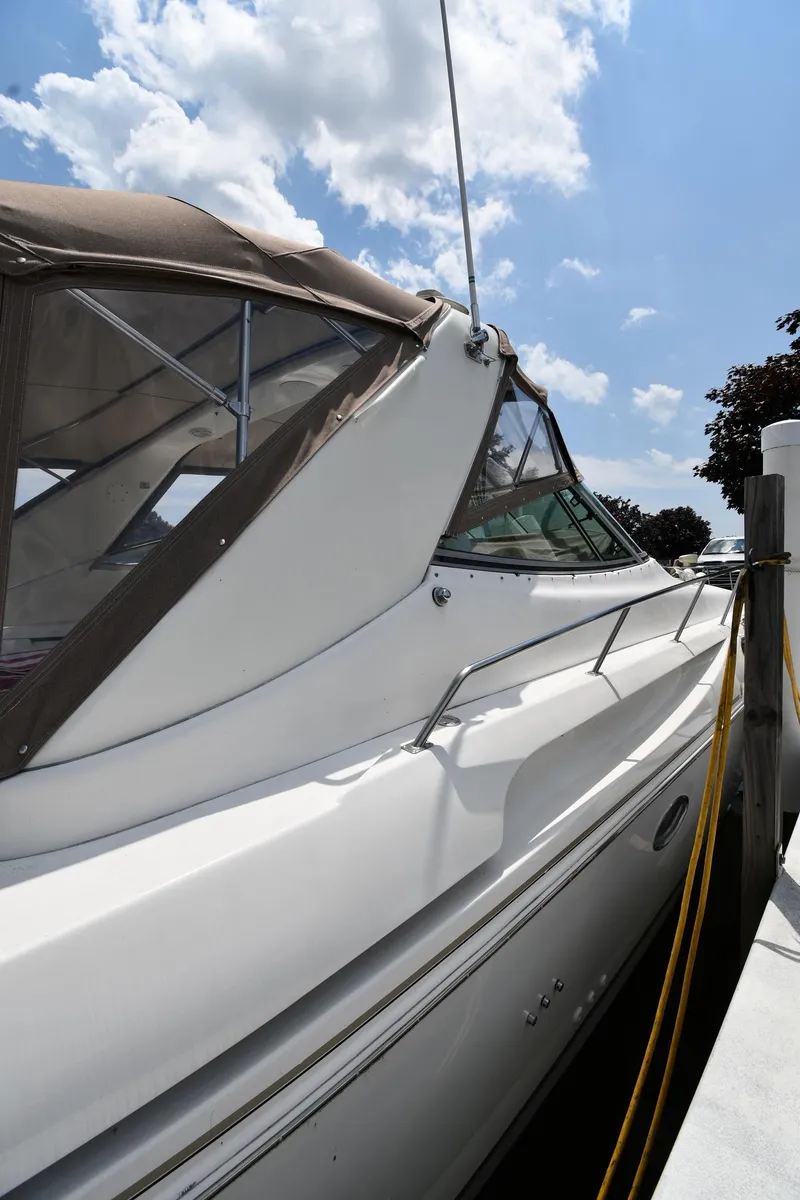 Slide: The Image of 1998 Cruisers Yachts 3870 Express docked under a sunny sky. - 2