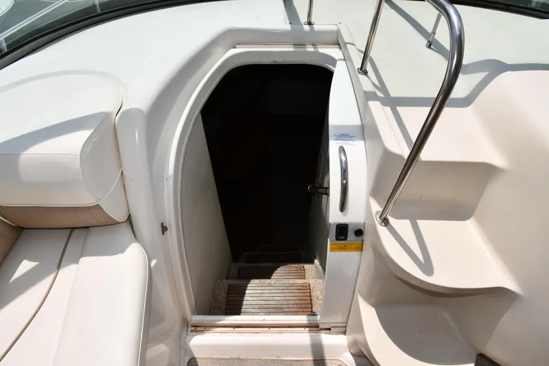 Slide: The Image of 1998 Cruisers Yachts 3870 Express cabin entrance with steps and railing. - 27