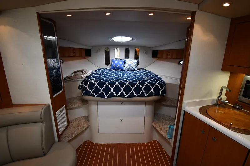 Slide: The Image of 1998 Cruisers Yachts 3870 Express interior cabin with bed, kitchenette, and seating area. - 28