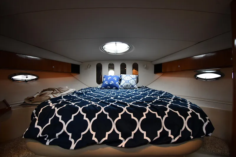 Slide: The Image of Luxurious cabin interior of 1998 Cruisers Yachts 3870 Express with cozy bed and porthole windows. - 29