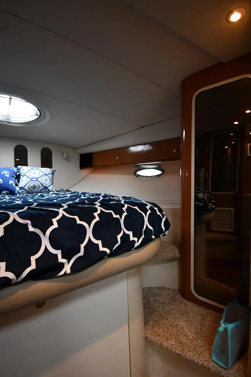Slide: The Image of 1998 Cruisers Yachts 3870 Express cabin interior with bed and mirror. - 30