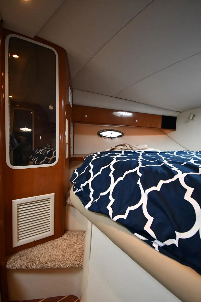 Slide: The Image of 1998 Cruisers Yachts 3870 Express cabin with bed and storage. - 31