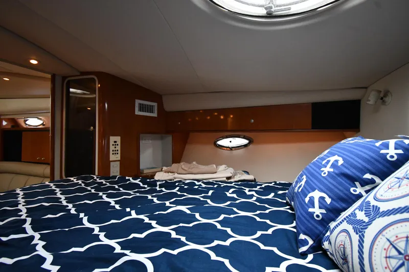 Slide: The Image of 1998 Cruisers Yachts 3870 Express cabin with nautical-themed bedding. - 32