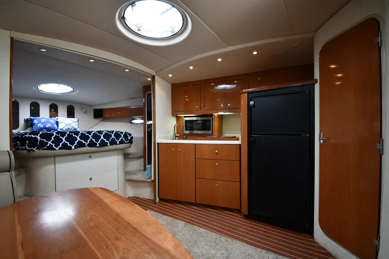 Slide: The Image of Interior of 1998 Cruisers Yachts 3870 Express with kitchen and sleeping area. - 34