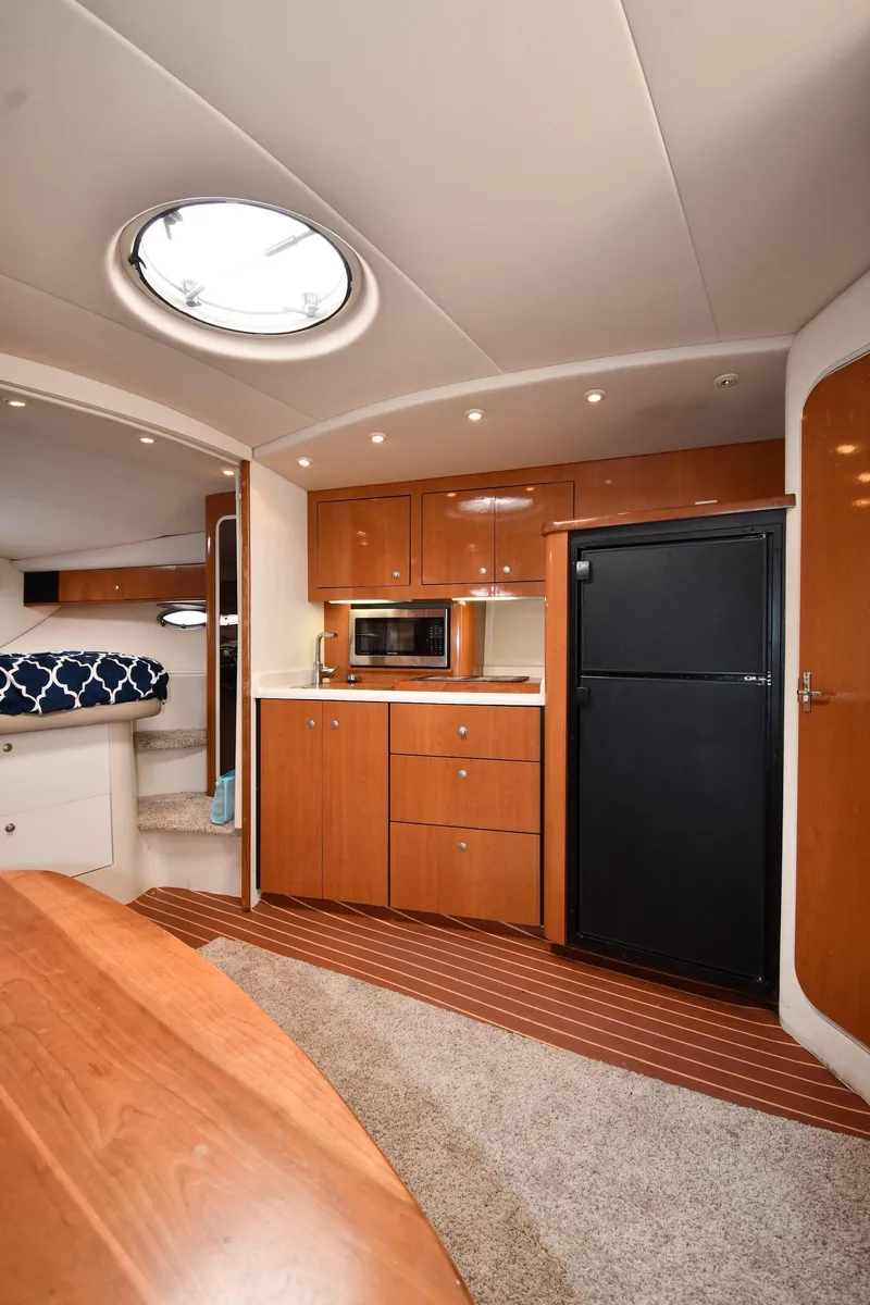 Slide: The Image of 1998 Cruisers Yachts 3870 Express interior with kitchenette and cozy cabin. - 35