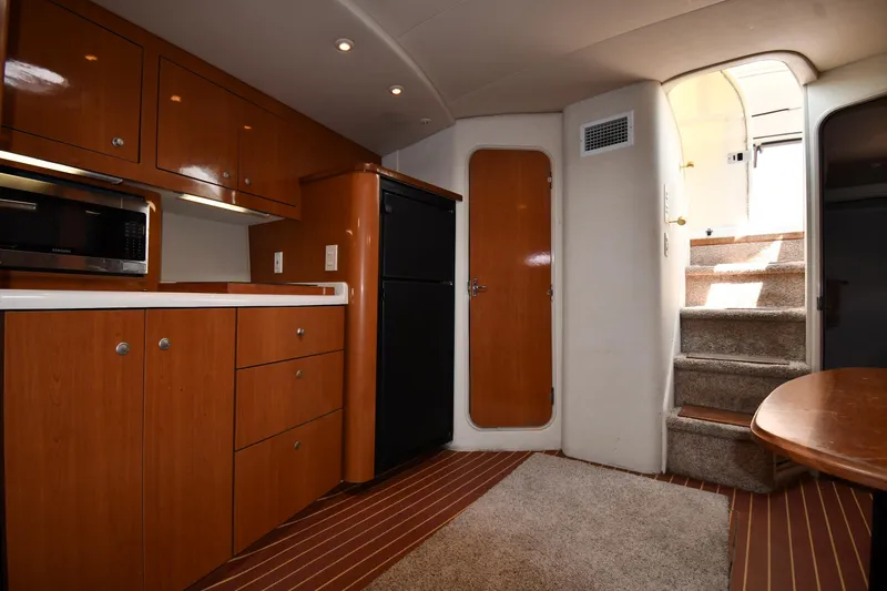 Slide: The Image of Interior of 1998 Cruisers Yachts 3870 Express with kitchenette and stairs. - 40