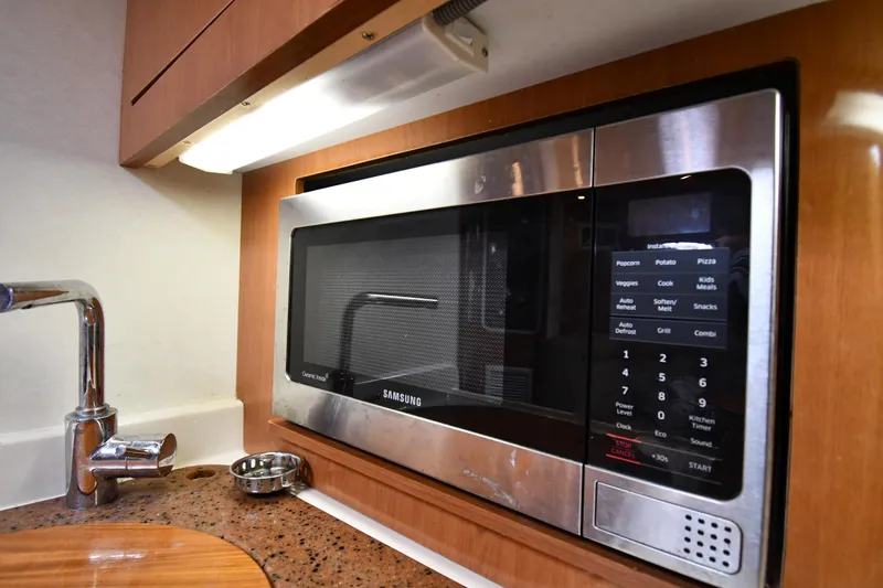 Slide: The Image of 1998 Cruisers Yachts 3870 Express kitchen with Samsung microwave and modern fixtures. - 46