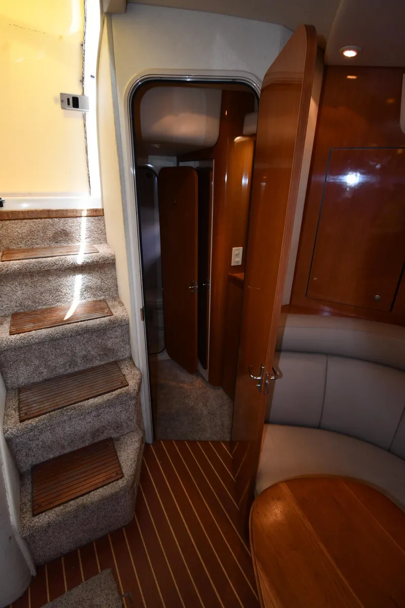 Slide: The Image of Interior of 1998 Cruisers Yachts 3870 Express with carpeted stairs and wooden cabinetry. - 49
