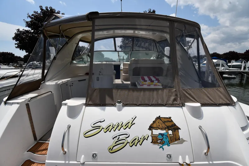 Slide: The Image of 1998 Cruisers Yachts 3870 Express boat named Sand Bar docked at a marina. - 7